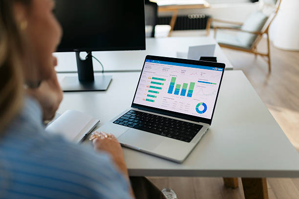 istock Woman analyzing business data with laptop in office 2244866133