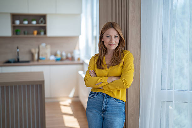 istock Confident woman smiling with crossed arms in modern kitchen 2244867527