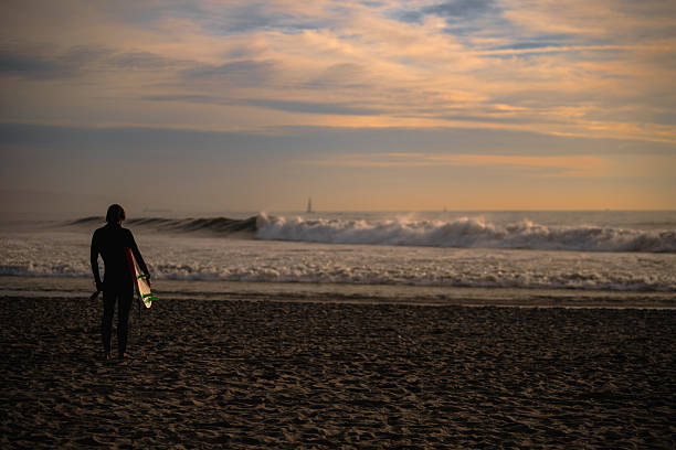 Male surfer, run and sunrise at beach, waves and exercise or hobby in nature and ocean. Sports, sea and dawn for fitness or adventure for man athlete person, outdoors and alone on coast shore