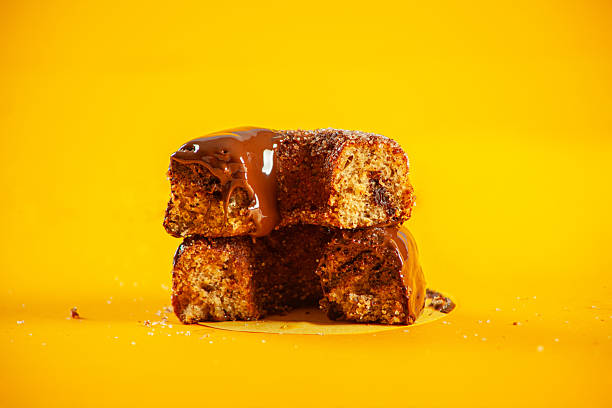 istock Chocolate sugared with melted icing and filling brioche doughnuts cut from the middle showing inside filling. 2244874025