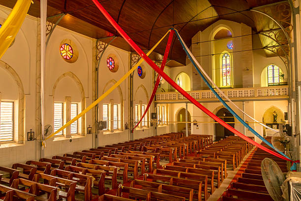 Praslin, Seychelles, February 3, 2025: A church with a red roof on Praslin, Seychelles, surrounded by palm trees and tropical vegetation editorial image