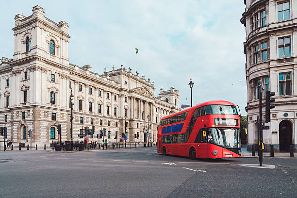istock Red double-decker bus driving through london street 2244876405