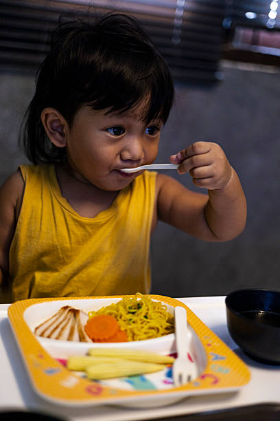 istock Toddler Is Eating Noodles With Soup 2244883244