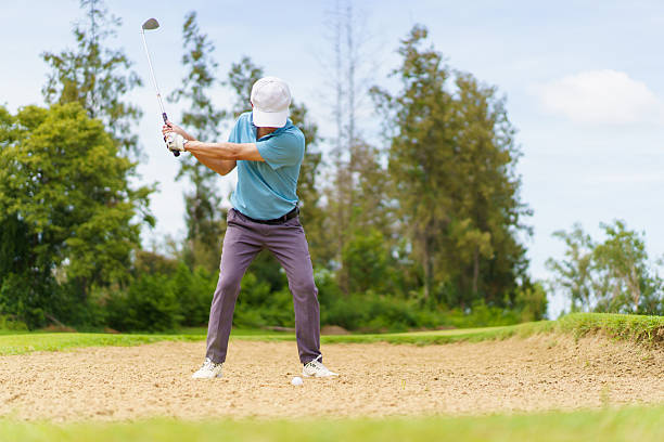 istock Asian male golfer hitting bunker shot from sand. 2244887270
