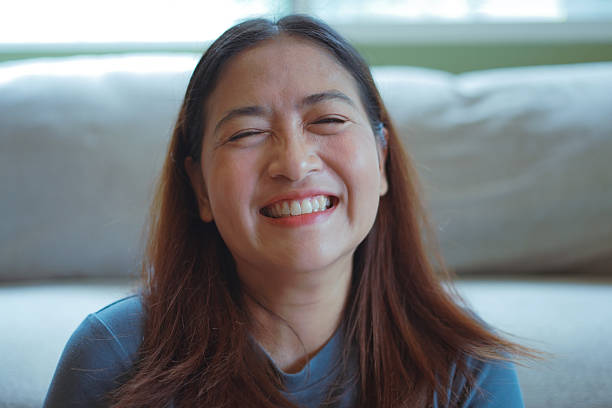 istock Close-up woman's face smiles brightly. 2244890359