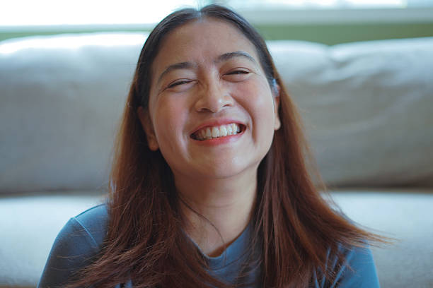 istock Close-up woman's face smiles brightly. 2244890361