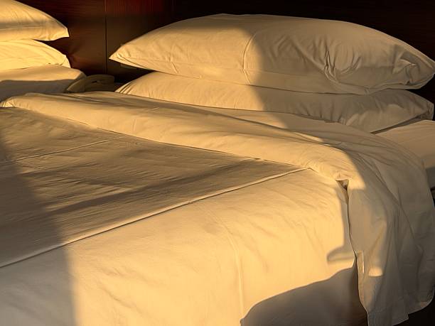 morning sunlight on pillows in bed