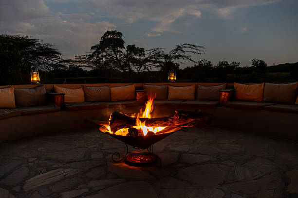 istock A cozy fire pit burns brightly, surrounded by comfortable seating in an outdoor lounge area at dusk 2244896902