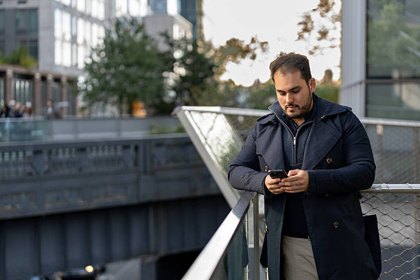 istock Man using a mobile phone in the city 2244900070