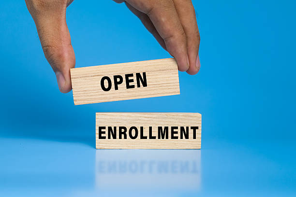 istock open enrollment words on wooden blocks isolated on blue background 2244901714