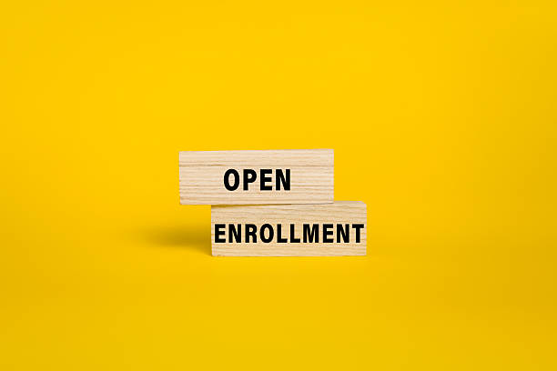 istock open enrollment words on wooden blocks isolated on yellow background 2244901717