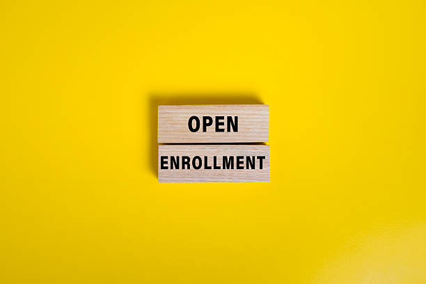 istock open enrollment words on wooden blocks isolated on yellow background 2244901882