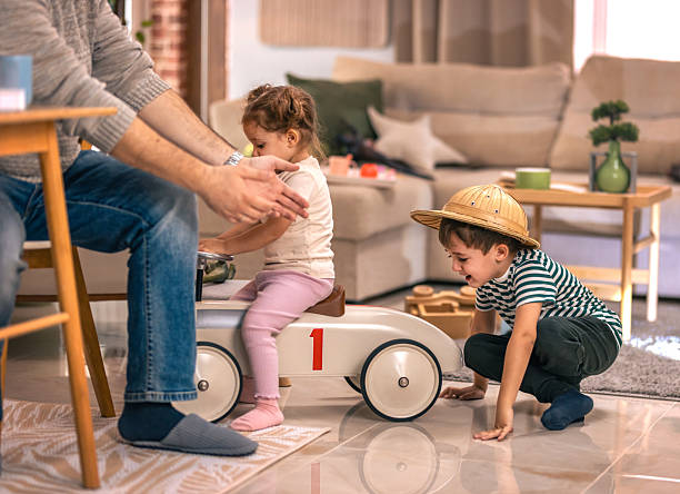 istock Father comforting his crying child while working from home 2244902179