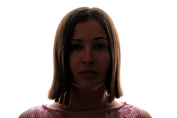 Dark silhouette of a young woman on a white background front view.