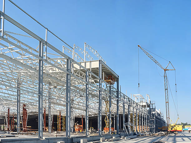 istock Construction site with crane and steel framework against a clear blue sky 2244903324