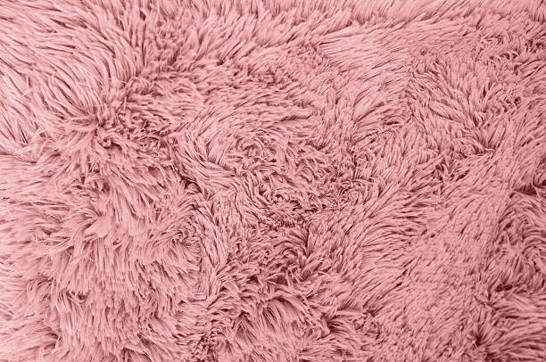 Soft, textured, rose-colored fabric blanket filling the frame, perfect for backgrounds and various design projects.