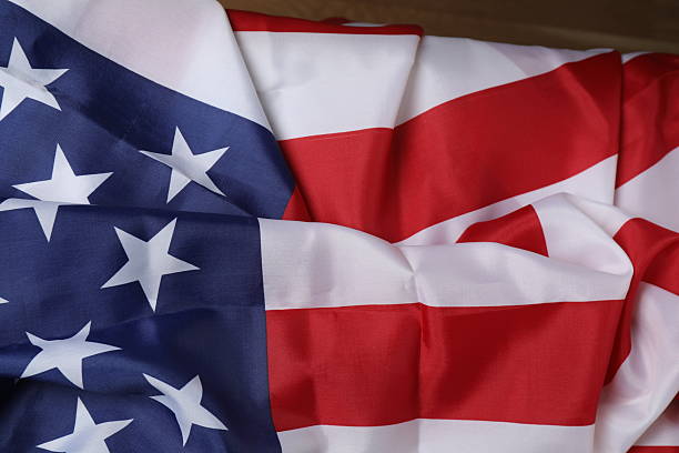istock Image of work gloves, tools, and the American flag on a concrete surface representing Labor Day in the USA 2244905400
