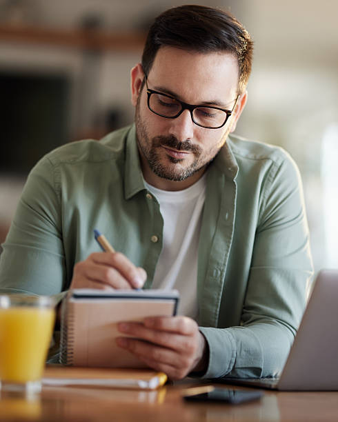 istock Young male entrepreneur writing at home office. 2244906742