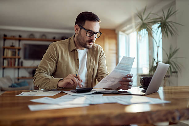 istock Young man working on his financial bills at home. 2244906796