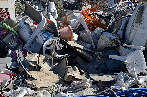The company for the disposal of cars, junk yard, scrappage of motor vehicles. The bodies of cars stacked in piles on the background of bare man-made hills