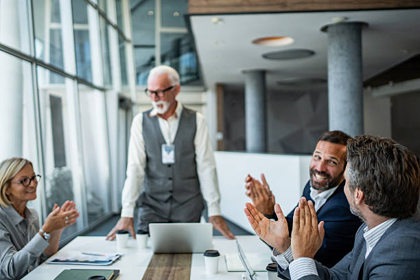 istock Business team applauding senior manager after successful presentation 2244907277