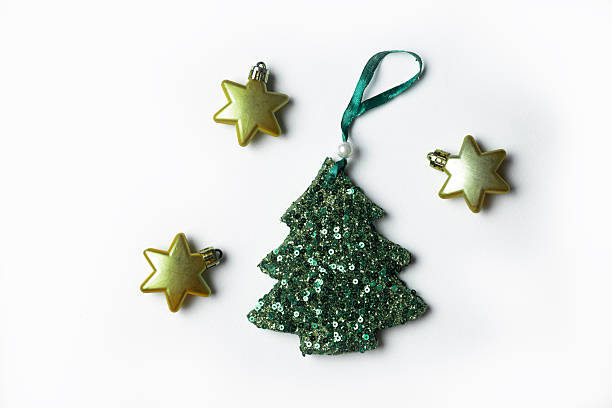 Star shaped ornaments and shiny green sequin Christmas tree on white background