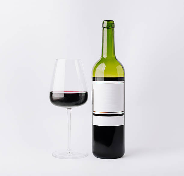 istock Elegant wine bottle and glass showcasing rich red wine in a minimal setting 2244908645