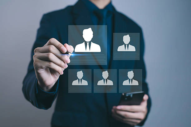 istock Businessman using digital interface to select employee profile, recruitment and HR management concept. Modern technology for online hiring, talent acquisition, and workforce analytics. 2244909016