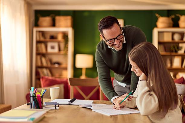 istock Dad Helps Daughter With Homework At Home During Cozy Family Study Session 2244909752