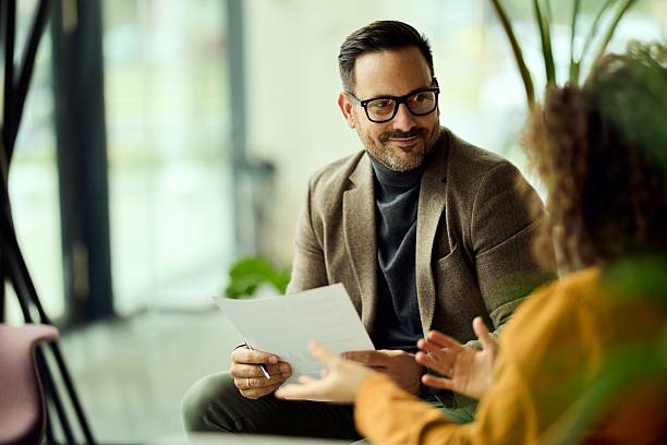 istock Professional Business Meeting In Modern Office: Man In Glasses Discussing Document With Colleague 2244909788