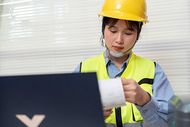 istock Asian female engineer uses a laptop or notebook to print barcode stickers on a barcode printer. 2244910362