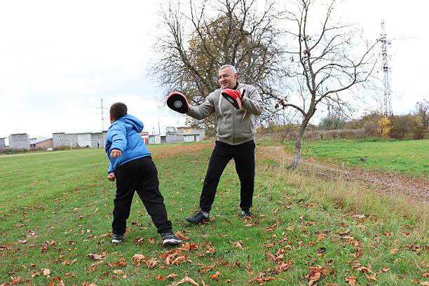 istock A man and a boy are training and practicing punches on training gloves 2244910445
