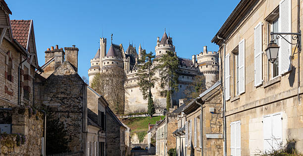 Pierrefonds, France -  April  7, 2021: The medieval Castle of Pierrefonds is an imposing fortress located at the edge of the forest of Compiègne, classified as a Historical Monument since 1862.