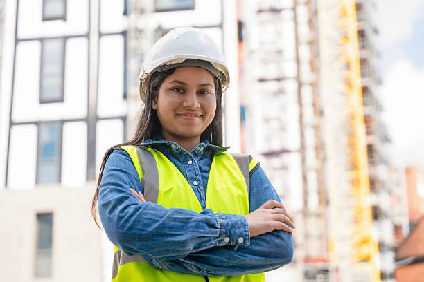 istock Portrait of builder woman posing in front of construction site 2244912882
