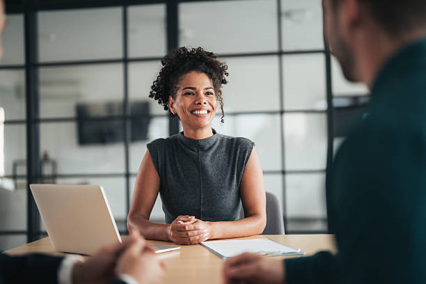 istock Insurance agents consulting clients in modern office 2244914350