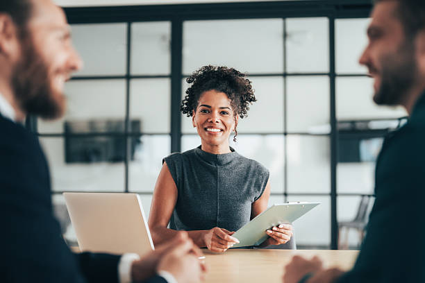 istock Insurance agents consulting clients in modern office 2244914352