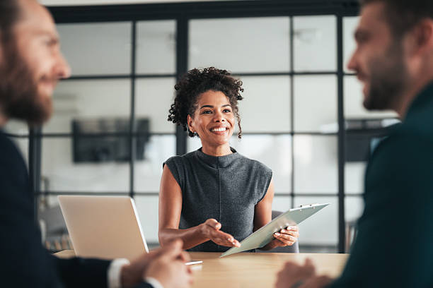 istock Insurance agents consulting clients in modern office 2244914363