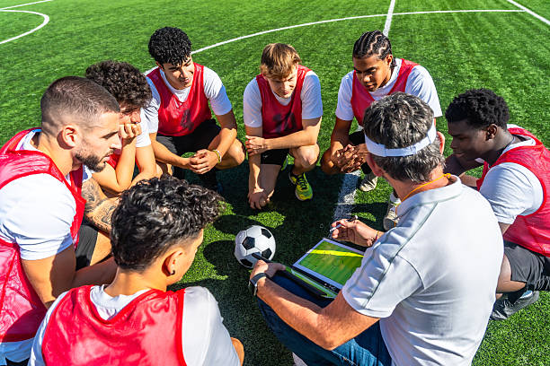 istock Soccer coach explaining strategy to diverse team on field 2244916584