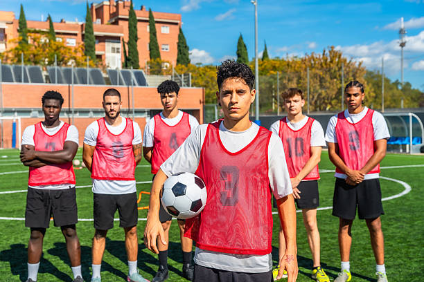 istock Young men soccer team posing on field with ball 2244916614