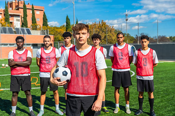 istock Young soccer players training on field with ball in hand 2244916633