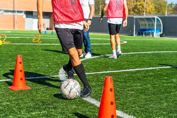 istock Soccer player training with ball and cones 2244916698