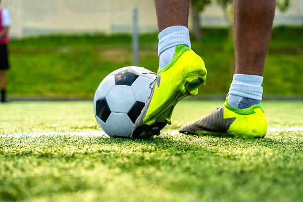 istock Soccer player controlling ball on green field 2244917321
