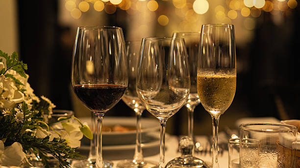 istock Red and white wine glasses on a beautifully set table. 2244919408