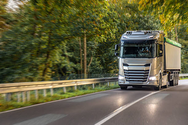 istock Large modern truck on winding road through green forest. Freight logistics. 2244922504