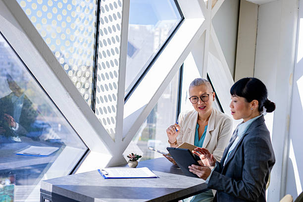 istock Female colleagues checking information on digital tablet at work 2244923818