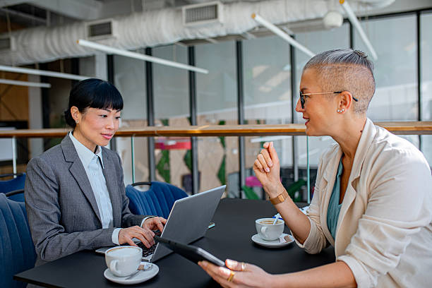 istock Confident female professionals discussing ideas in corporate environment 2244924715