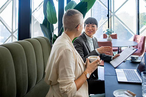 istock Confident female colleagues working together on laptop in stylish workspace 2244925749