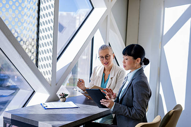 istock Female colleagues checking information on digital tablet at work 2244926095