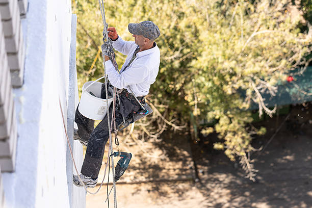 istock Construction worker insulates the exterior wall of a building with polystyrene panels at the height of the ninth floor. 2244926635