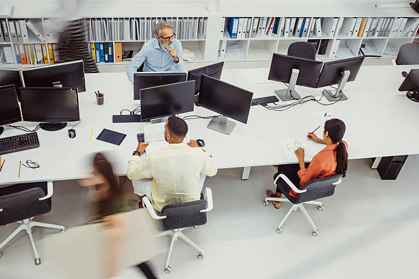 istock Diverse Employees Engaged in Architectural Tasks at Busy Office Biro 2244929332